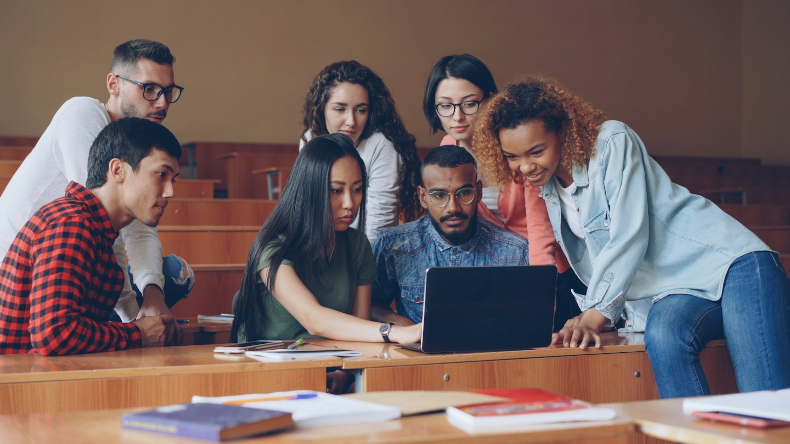 Young people learning to build with AI on laptops, The Genius Project