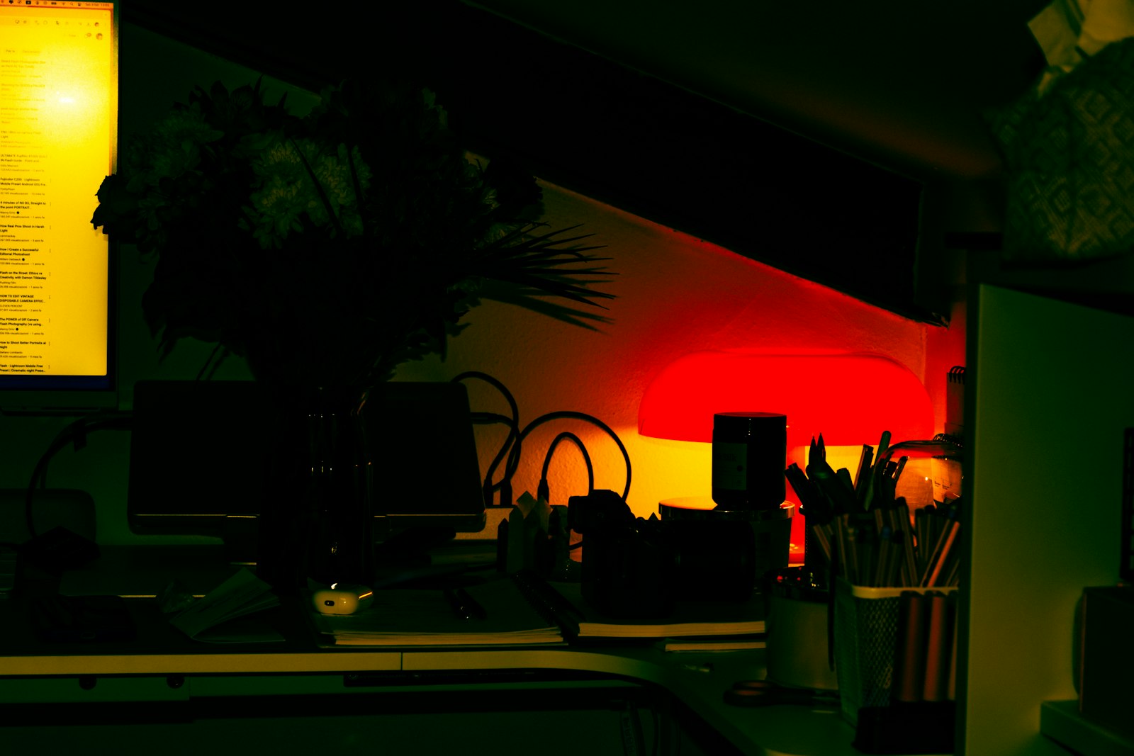 A dark office lit only by ambient desk lighting, representing the overnight window in which AI agents now run business workloads without a person present