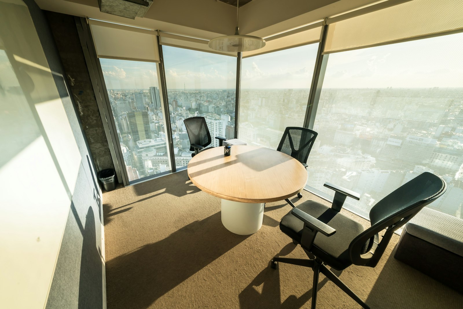 A modern meeting room with a city view, representing the board and executive setting where AI programmes are approved and, less often, run