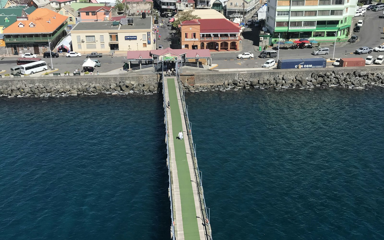 People on a pier beside the waterfront in Dominica