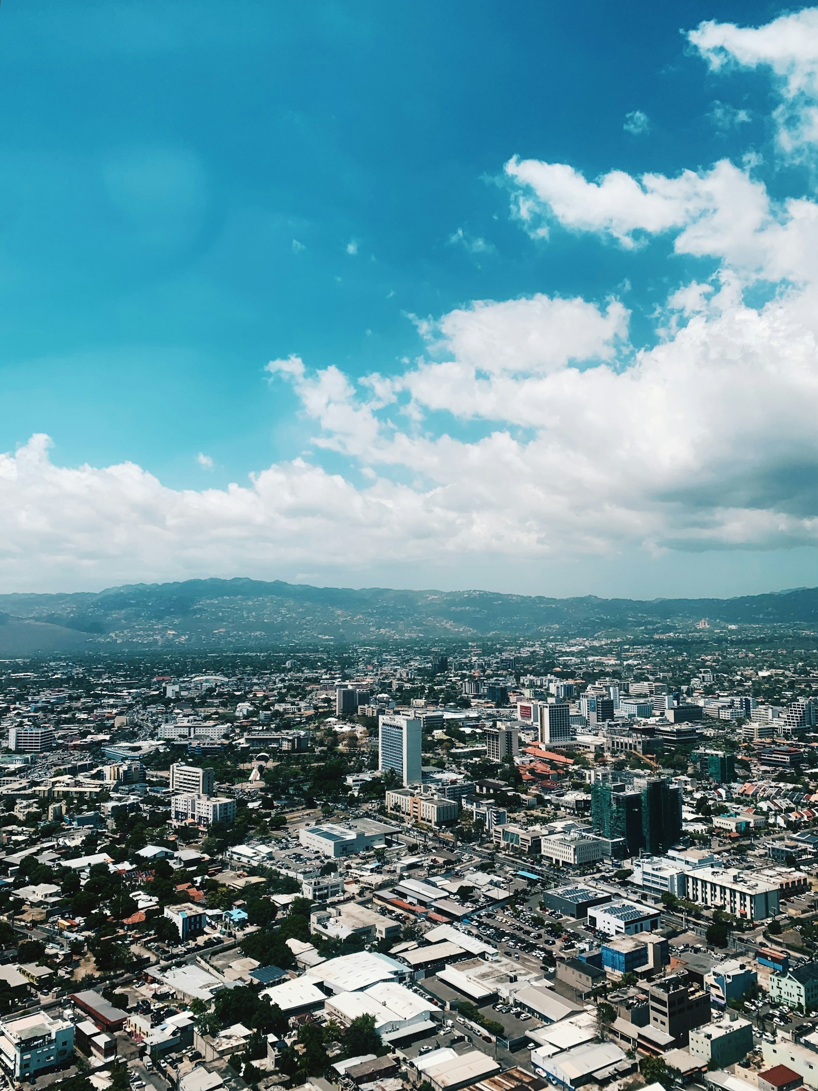 Aerial view of Kingston, Jamaica, with the Blue Mountains in the background, showing the business district where automation vendors are now pitching Caribbean boards
