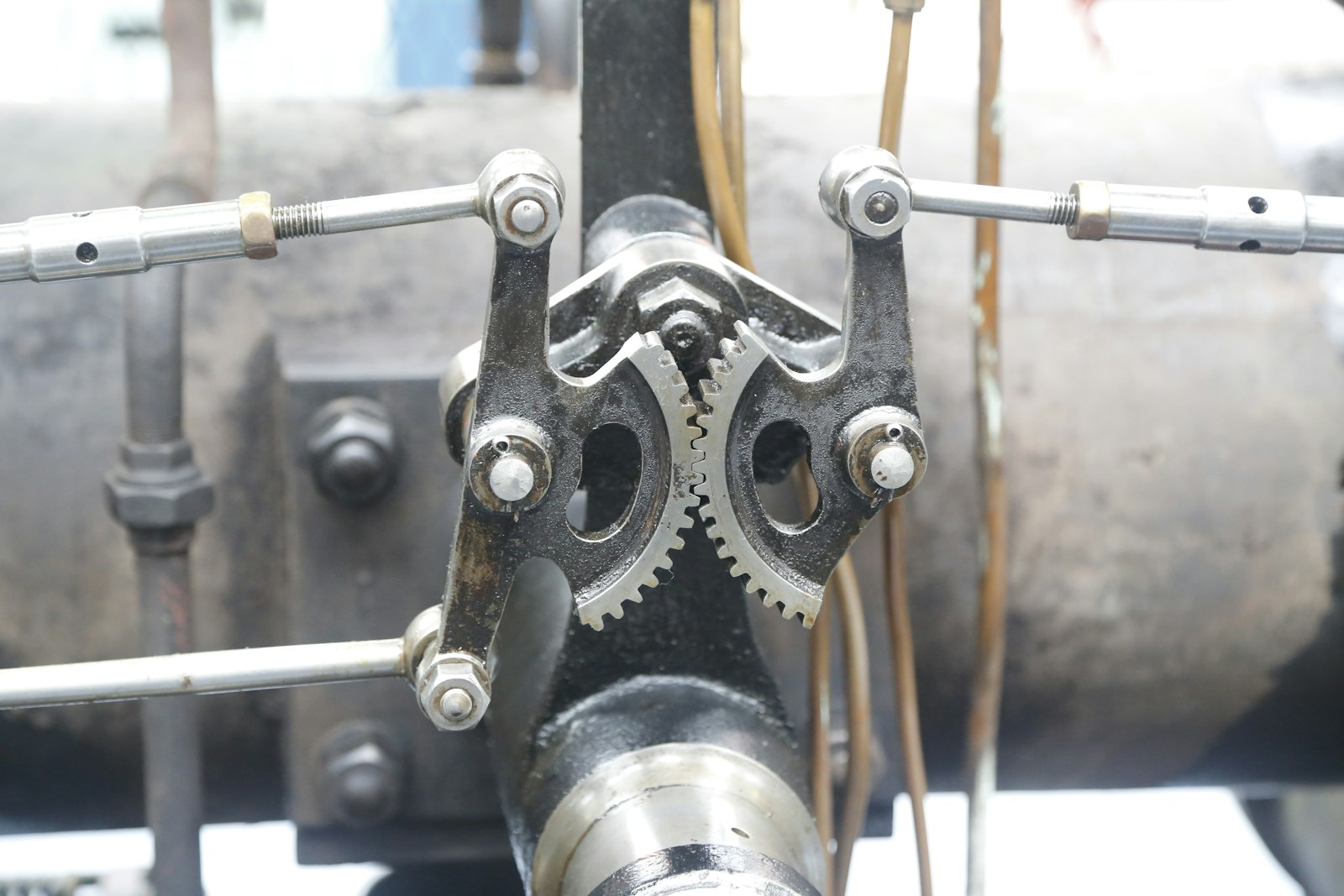 Close-up of interlocking mechanical gears on an old steam engine, representing the underlying process that has to be fixed before it can be automated